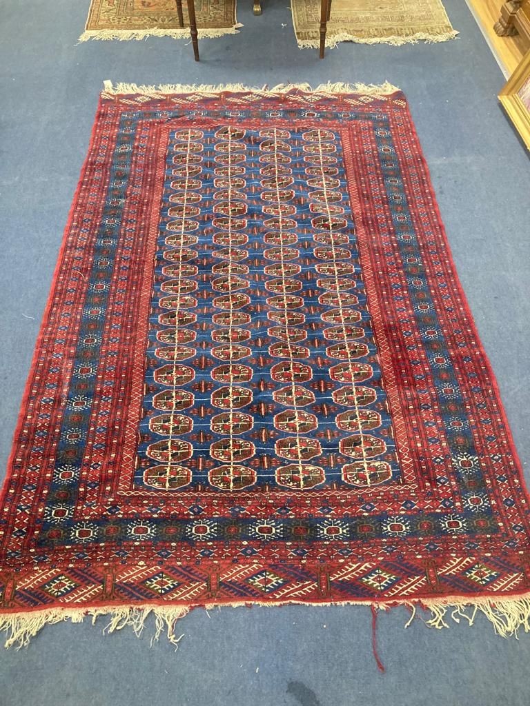 A Bokhara blue ground carpet. 240x150.